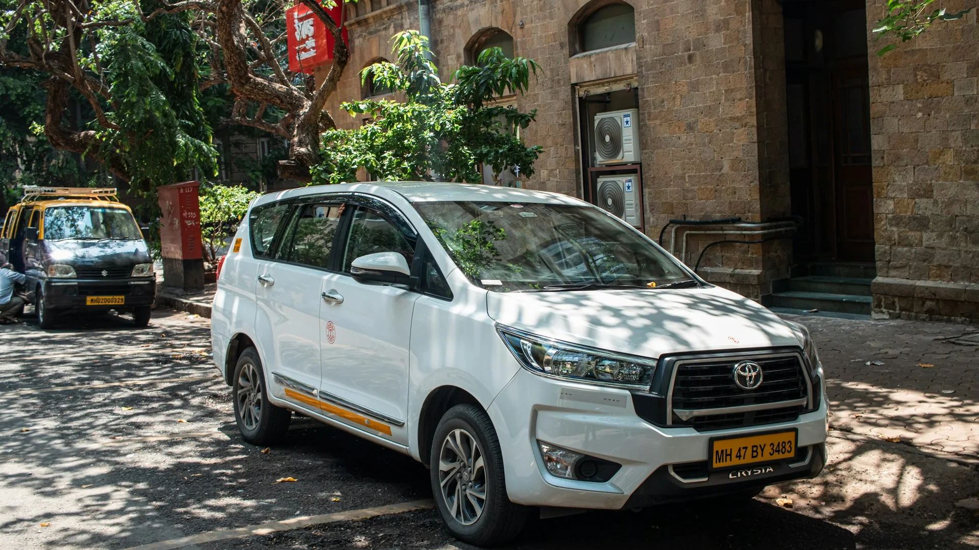 Professional corporate cabs waiting outside a modern IT office